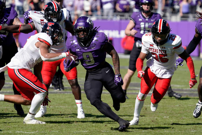 TCU Horned Frogs running back Emani Bailey (9) carries the ball against the Texas Tech Red Raiders during the second half of a game at Amon G. Carter Stadium.